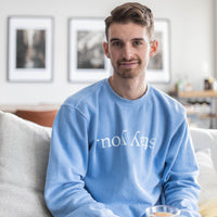 Model wearing the Stay You crewneck in Pigment Old South Blue, front view showing the upside-down stay you print