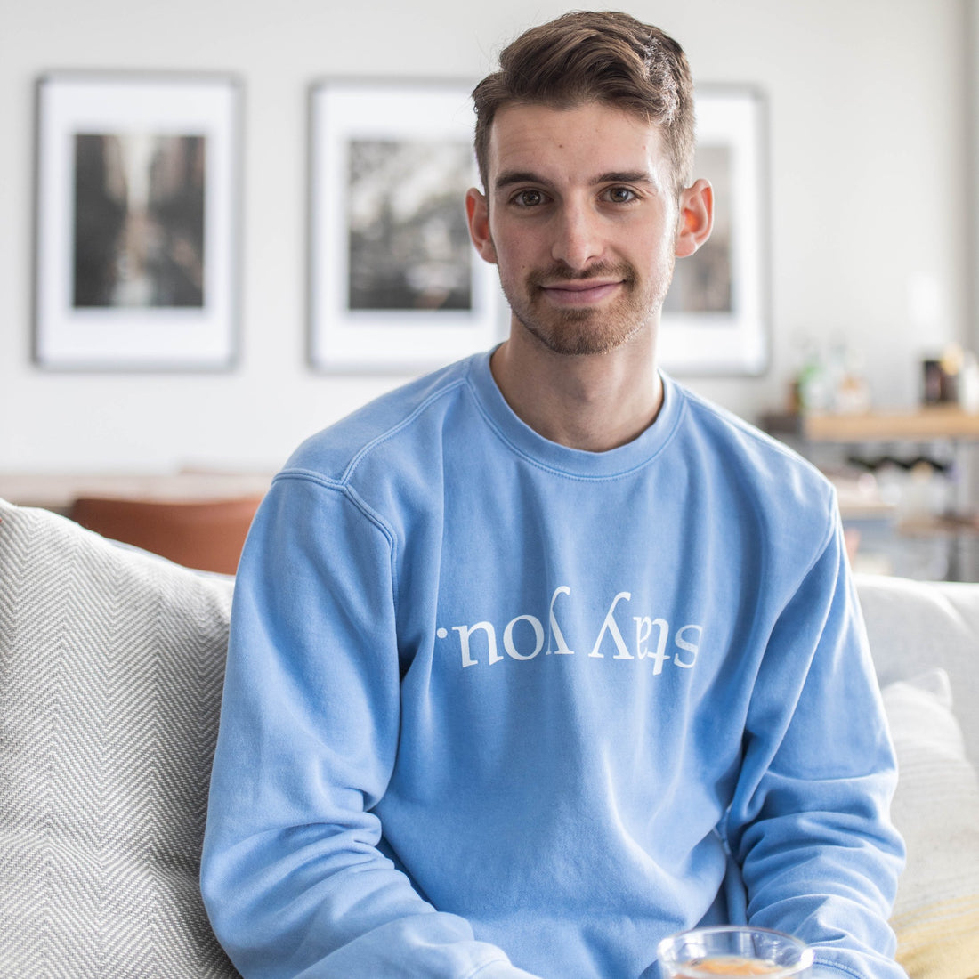 Model wearing the Stay You crewneck in Pigment Old South Blue, front view showing the upside-down stay you print